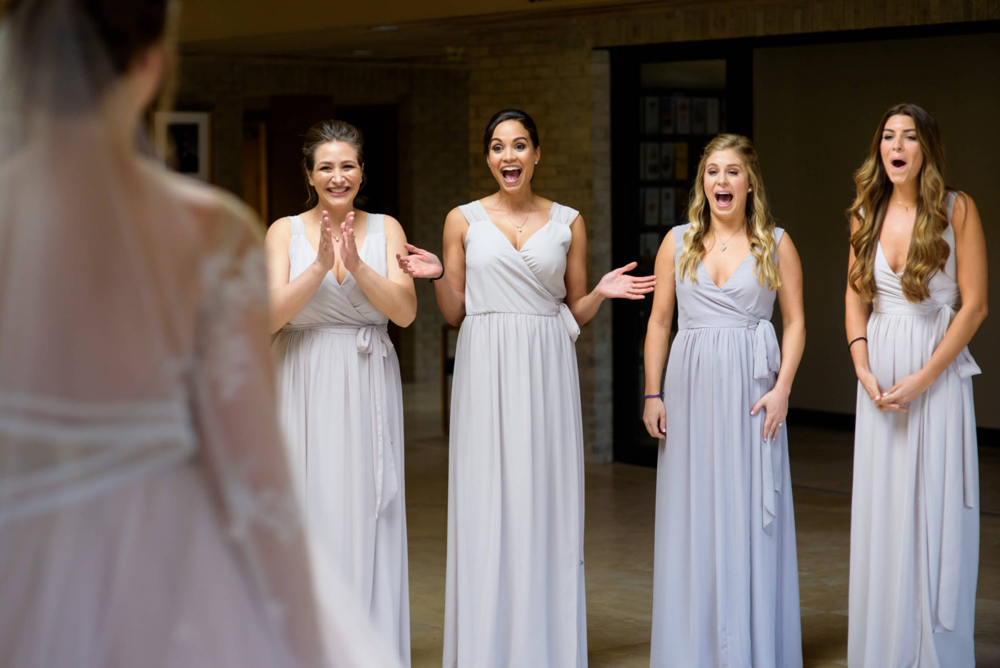 bridesmaids surprised bride wedding dress