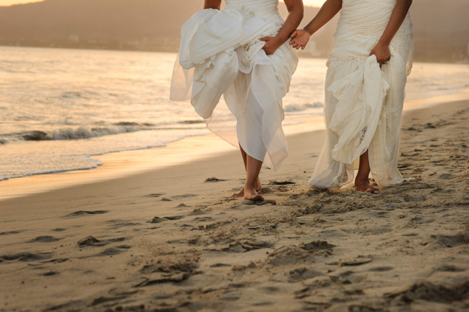 brides walk beach lesbian gay wedding