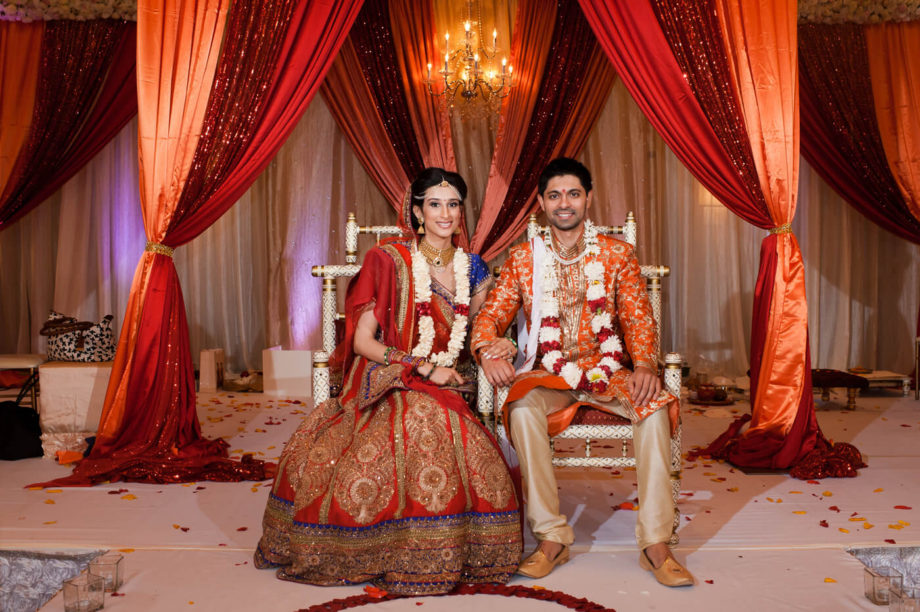 Indian bride groom stage mandap sitting portrait