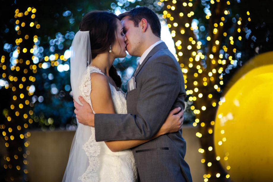 bride groom kissing portrait night lights bokeh