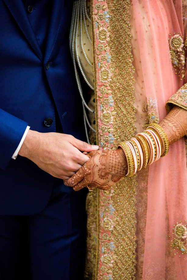Indian groom bride holding hands detail